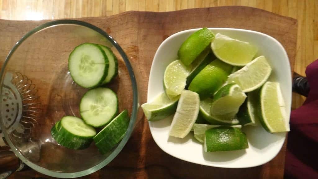 cucumbers and limes in a bowl waiting to become a cucumber lime dirnk