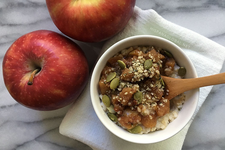 Steel cut oatmeal with homemade apple cinnamon compote and pepita, hemp seed and flaxseed topping. A filling and nutritious breakfast that's easy to make and so delicious! Recipe via hispanaglobal.net