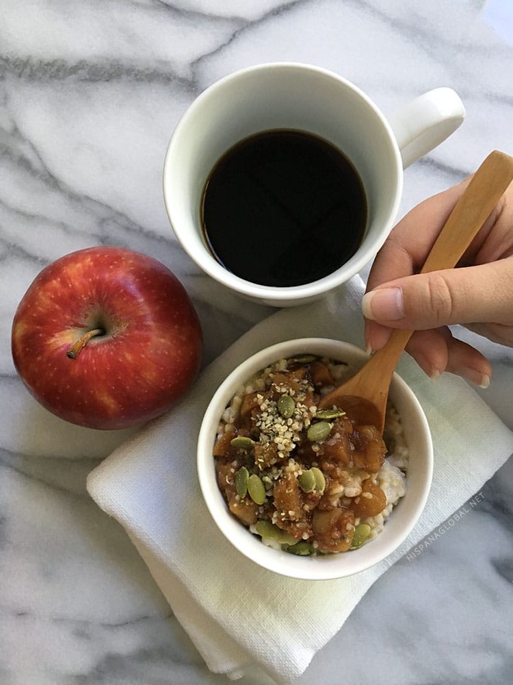 Steel cut oatmeal with homemade apple cinnamon compote and pepita, hemp seed and flaxseed topping. A filling and nutritious breakfast that's easy to make and so delicious! Recipe via hispanaglobal.net