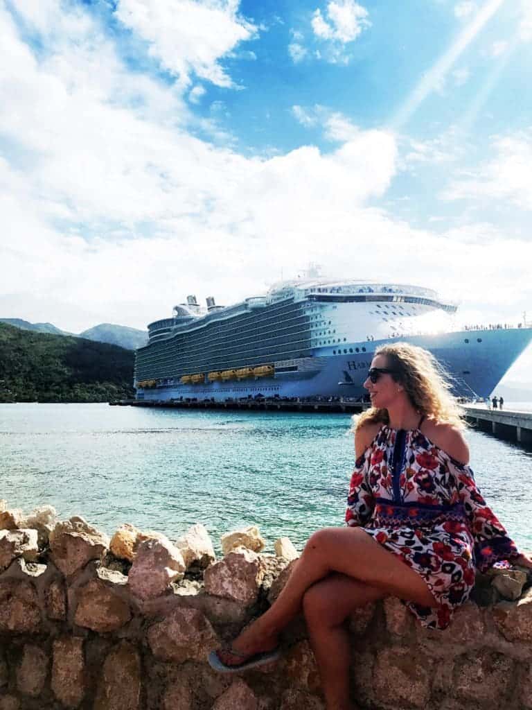 Woman sitting in front of cruise ship