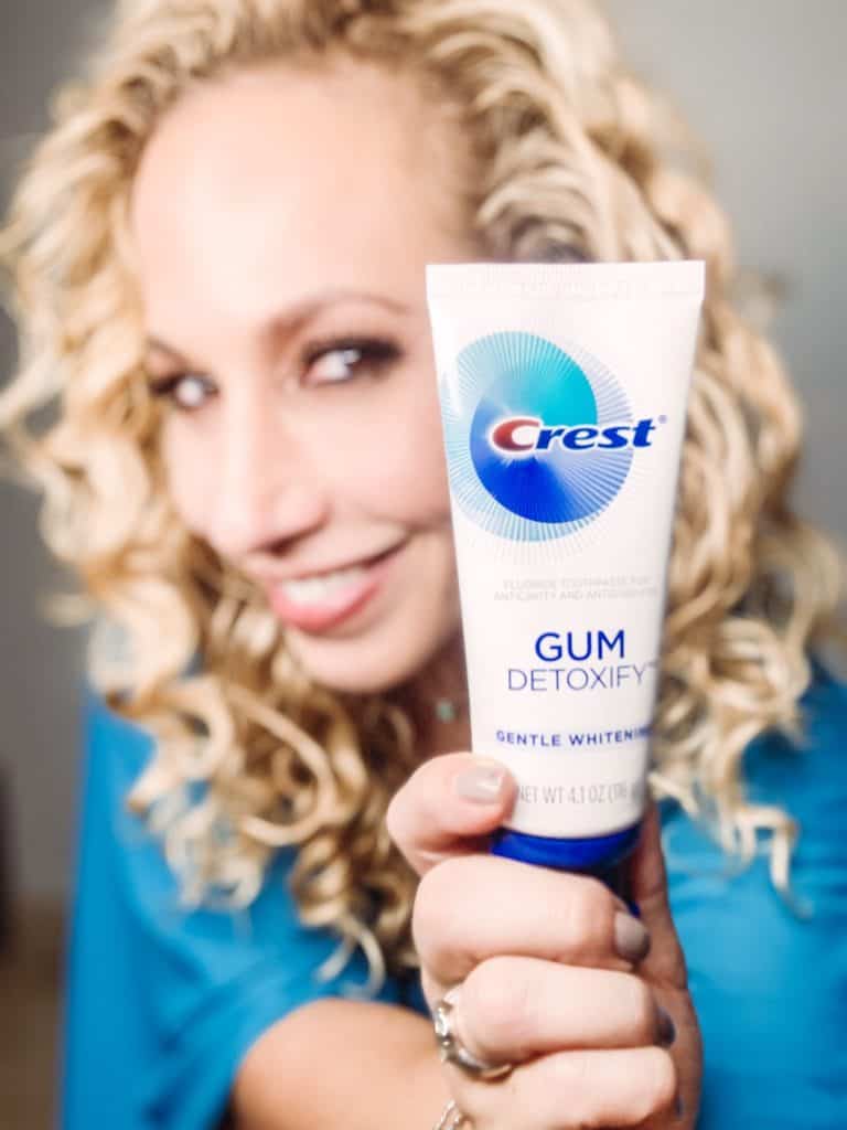 Woman holding Crest Gum Detoxify