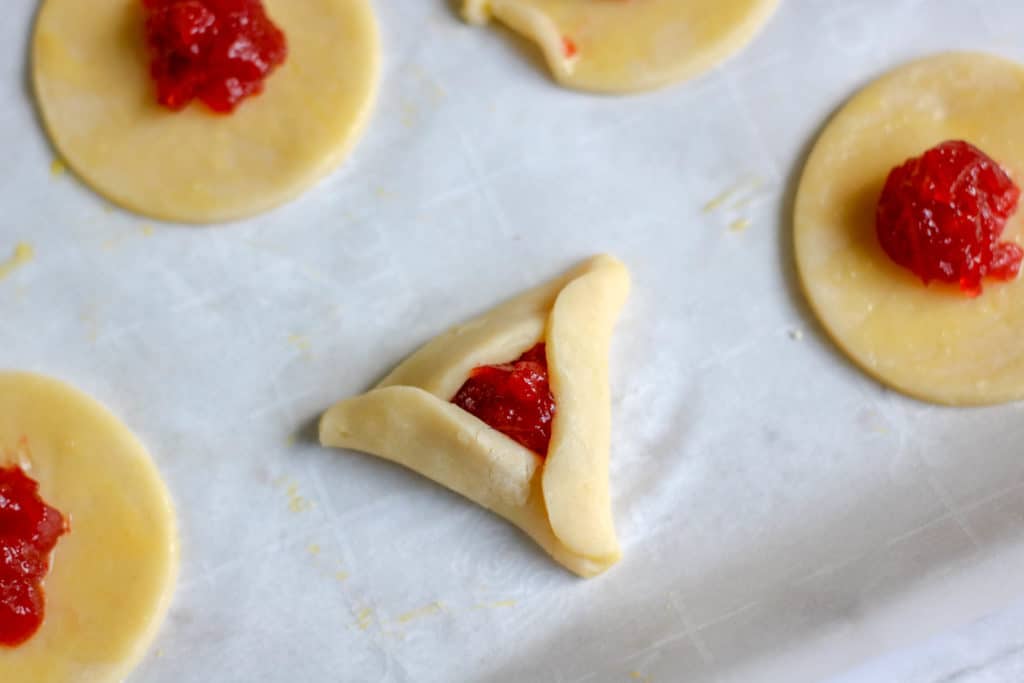 During the Jewish holiday of Purim, it's a tradition to serve cookies resembling Haman's ears. Here is an easy and delicious strwaberry hamantaschen recipe.