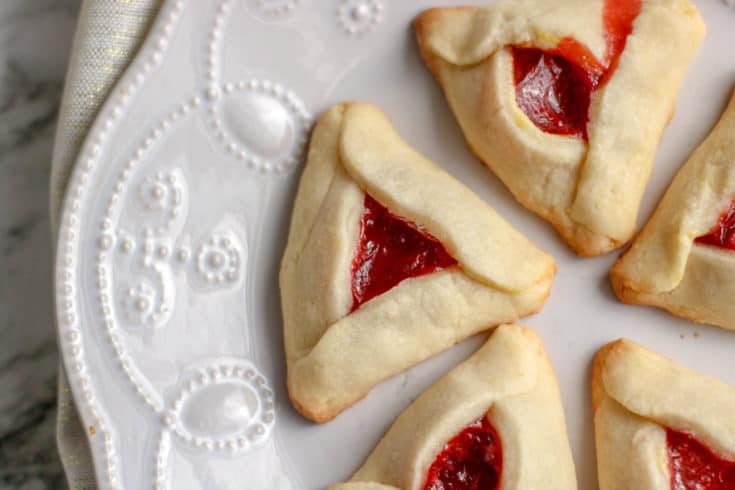During the Jewish holiday of Purim, it's a tradition to serve cookies resembling Haman's ears. Here is an easy and delicious strwaberry Hamantaschen recipe.
