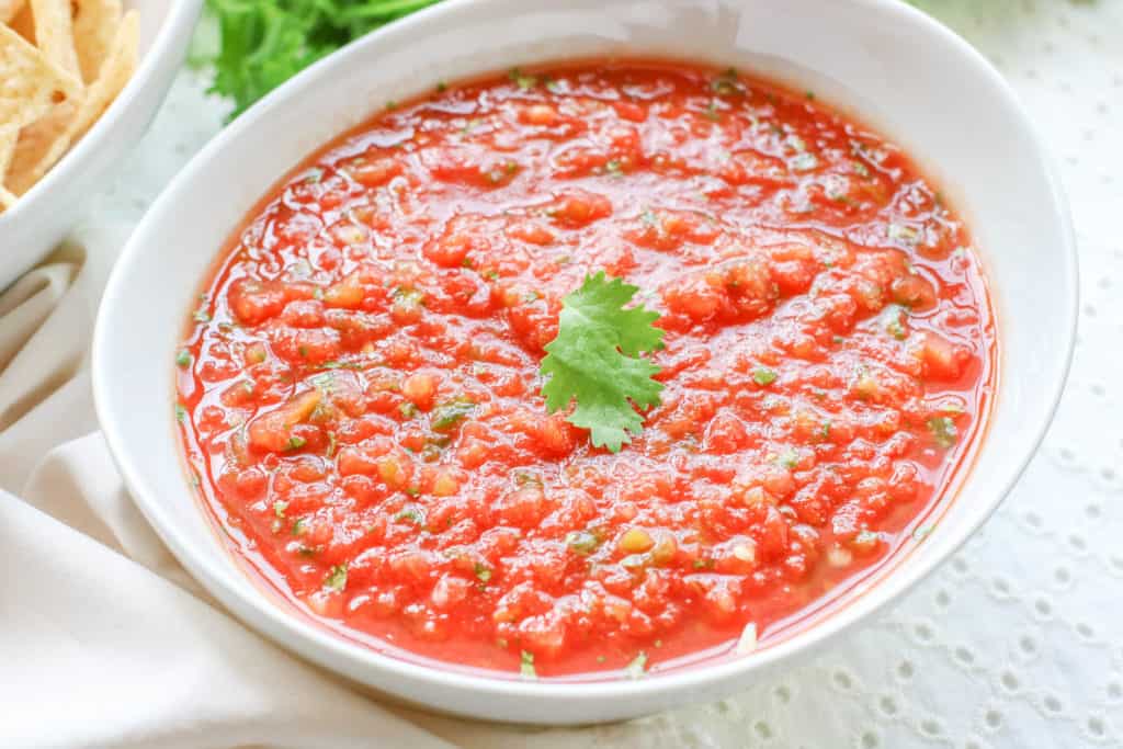 This homemade salsa recipe is easy to make, delicious, and uses canned tomatoes. It's perfect for chips, tacos, and quesadillas!
