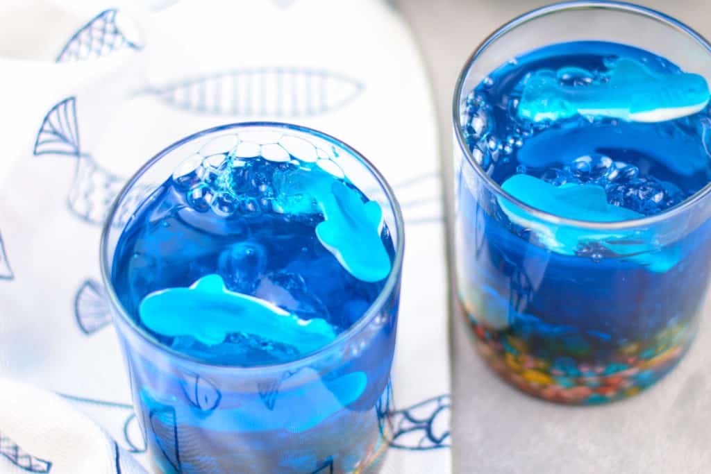 These delicious and colorful shark Jello aquarium cups are the perfect no-bake summer dessert, plus they're the perfect treat for Shark Week!