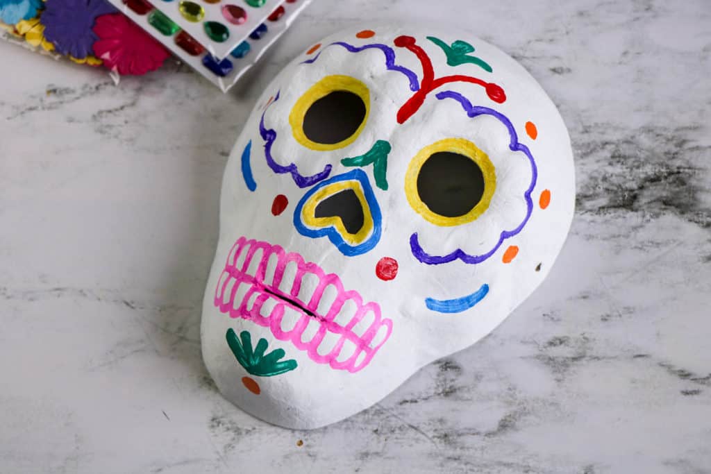 If you celebrate the Day of the Dead or Día de los Muertos, have the children make calaveras or skulls. Here is an easy craft that will look beautiful on any altar.