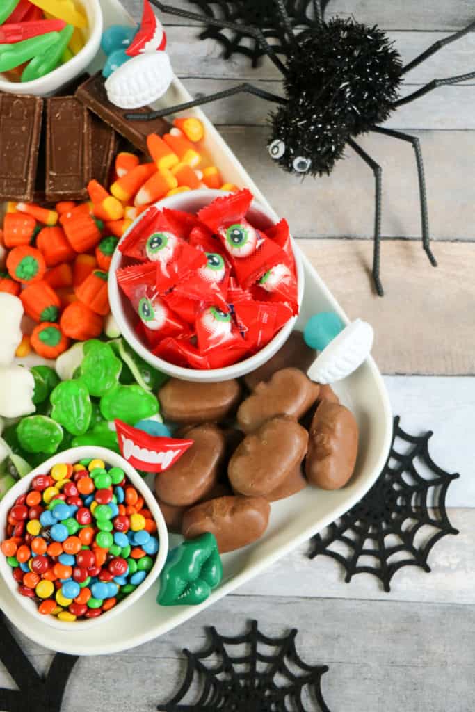 This colorful Halloween candy charcuterie board is the perfect way to serve spooky treats. It's also so easy to make!