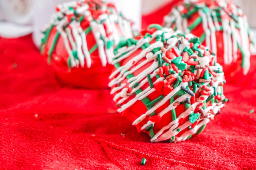 These are the most festive hot cocoa bombs you can make at home. They have hot chooclate, marshmallows, and nougat to create a delightful explosion of flavor and color.