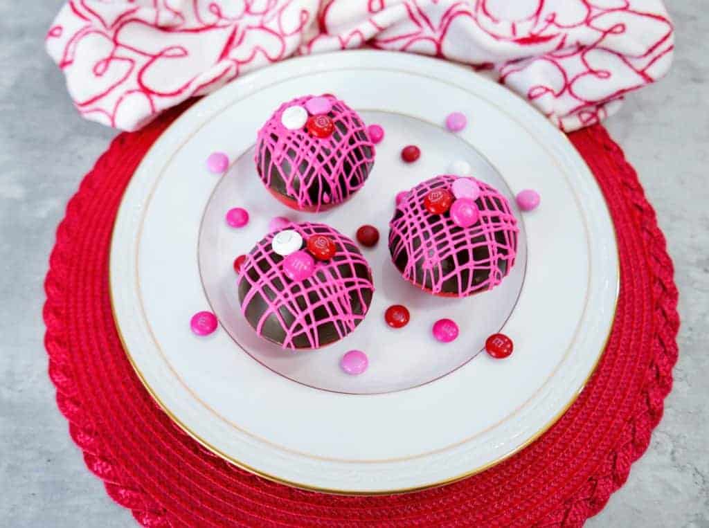 These gorgeous hot cocoa bombs have M&M's so they are extra delicious. The dark chocolate shell balances the flavors so you can enjoy a delicious cup of hot chocolate!