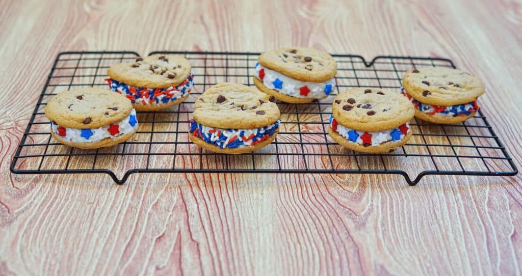Whip up a batch of these 4th of July Cookies today. A sandwich cookie that is decorated with festive sprinkles. A delicious patriotic cookie!