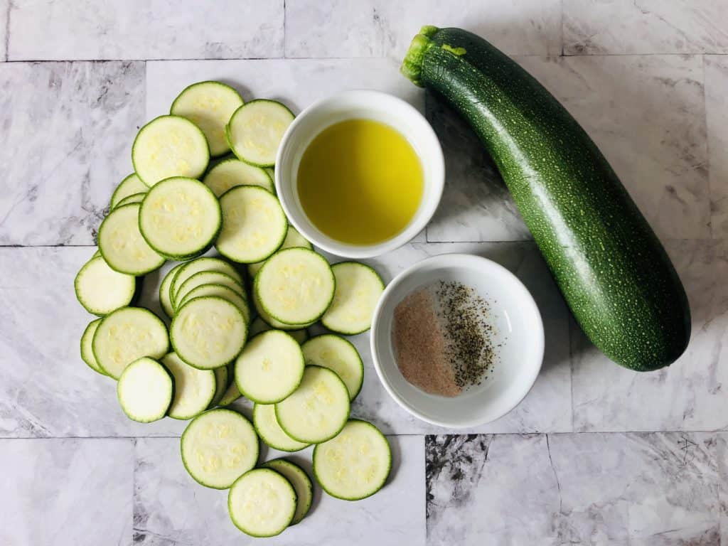 Ingredients for Zucchini Chips on a marble counter