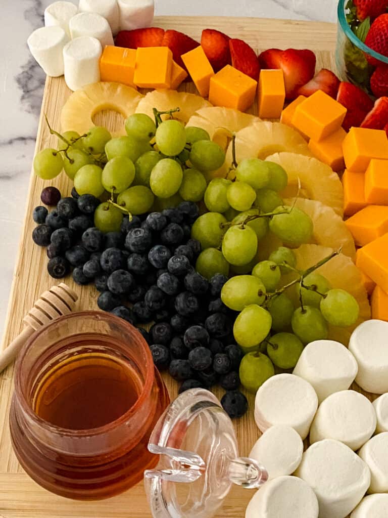 A rainbow fruit board is so visually appealing and it's also packed with nutrients. So perfect for any table, especially for St. Patrick's Day, a unicorn-themed party or any family event.