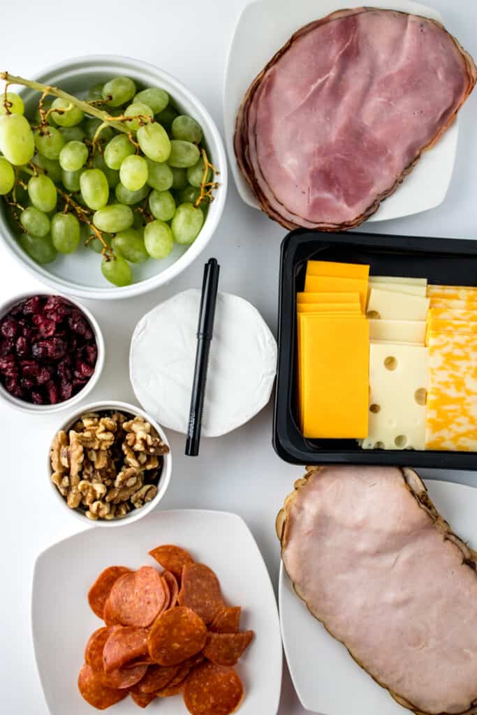 Learn how to make an exquisite New Year's Eve charcuterie board that promises to tantalize the taste buds with your favorite cheeses, meats and fruit. These are the ingredients.