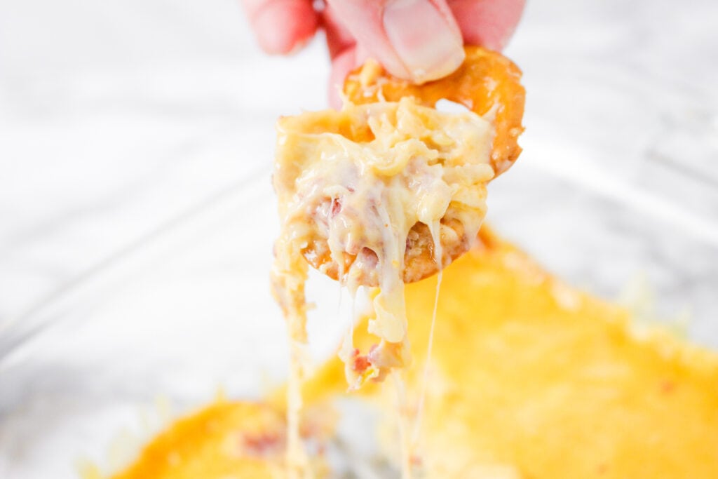 This easy hot Reuben Dip recipe is the perfect appetizer. It brings together the flavors of savory corned beef, sauerkraut and creamy Thousand Island dressing.
