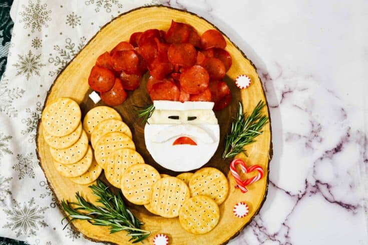 This adorable Santa Brie board will become one of your favorite holiday appetizers. In just a few minutes make a festive Santa Claus Brie board that will become the star of your Christmas party.