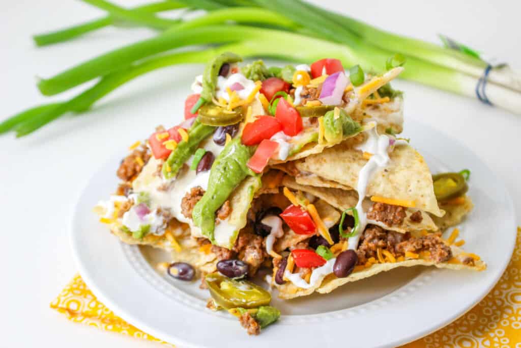 Score big on game day with our epic Trash Can Nachos recipe! Layered with crispy tortilla chips, gooey queso, savory taco meat, and fresh toppings, this crowd-pleaser is easy to make and even easier to devour.