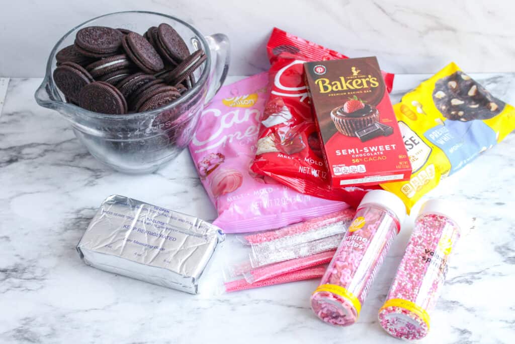 Discover the perfect Valentine's Day treat with our easy no-bake Oreo truffle recipe. Simple ingredients transform into delicious, bite-sized truffles with pink candy coating, ideal for gifting or indulging.  These are the ingredients.