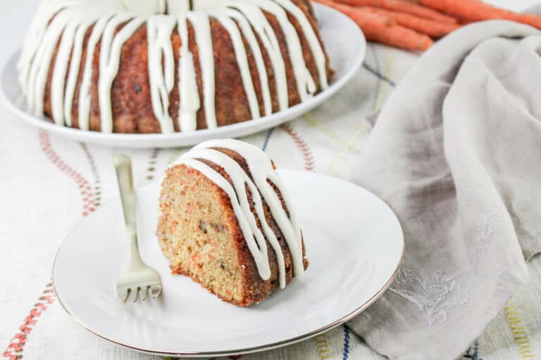 This easy carrot cake pound cake is perfection. The homemade cream cheese frosting is drizzled on top for the most delicious, moist and satisfying cake.