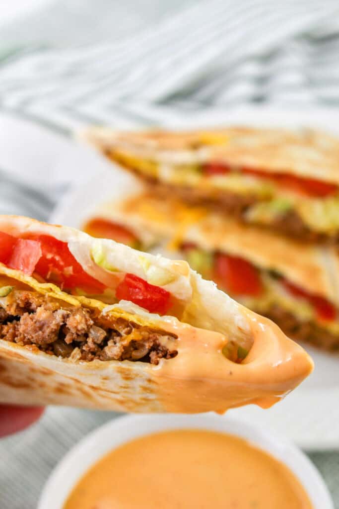 This ultimate cheeseburger crunchwrap recipe is so satisfying and easy to make! The secret ingredient is a crispy tostada shell strategically placed in the middle of the wrap so it is extra crunchy every time you bite into your burger.