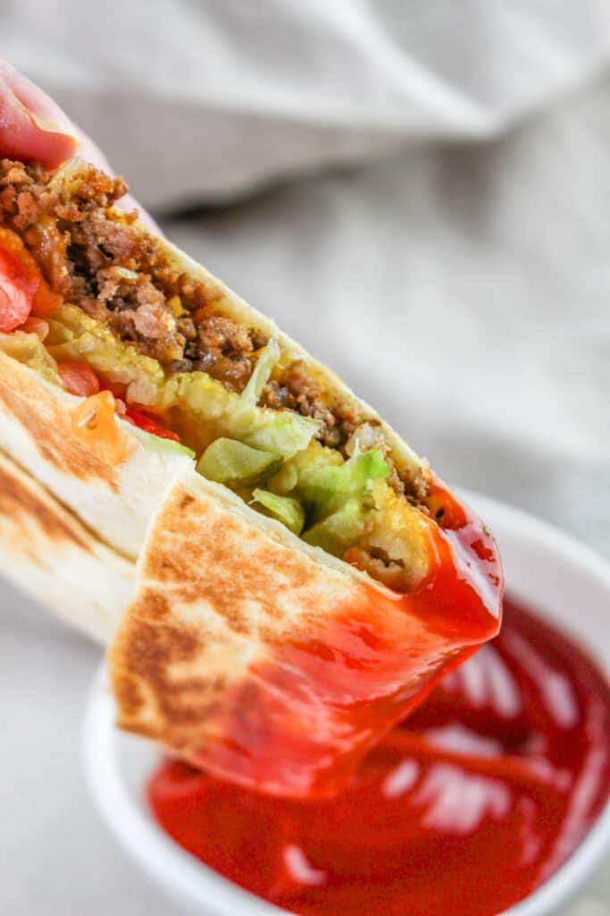 This ultimate cheeseburger crunchwrap recipe is so satisfying and easy to make! The secret ingredient is a crispy tostada shell strategically placed in the middle of the wrap so it is extra crunchy every time you bite into your burger.