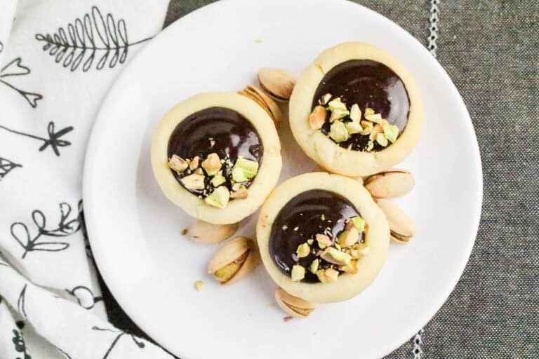 This easy chocolate mini tarts recipe features buttery tart shells filled with rich chocolate ganache. Perfect for parties, holidays, or special occasions—make ahead and top with pistachios, berries, or sea salt.