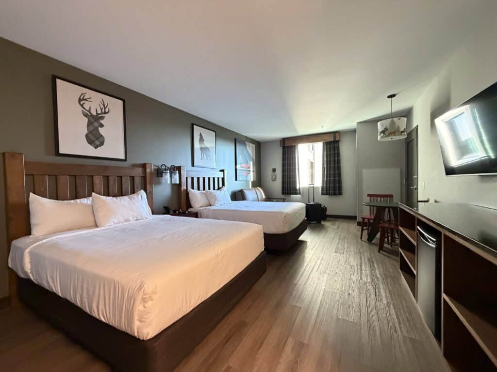 Relaxing hotel room with two comfortable beds, modern decor, and natural light, ideal for travelers seeking comfort and convenience.